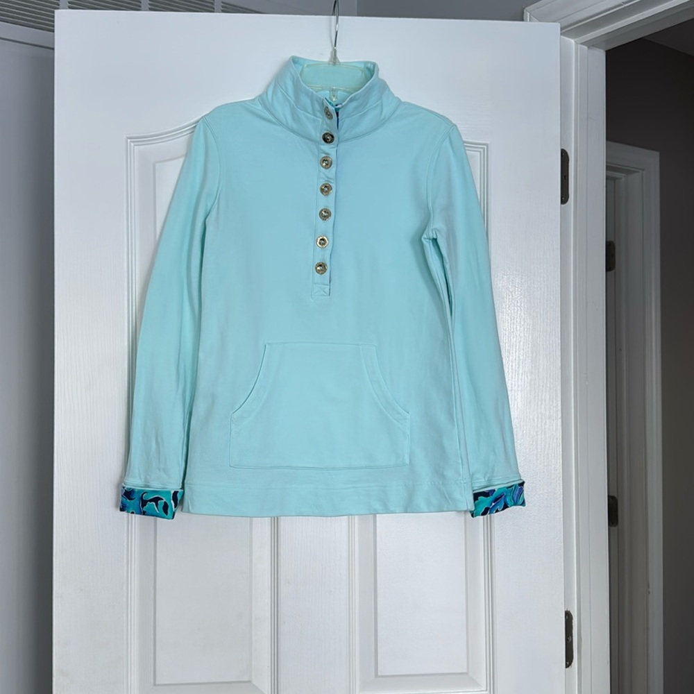 Cute half button up top with a pretty pattern on the collar and cuff